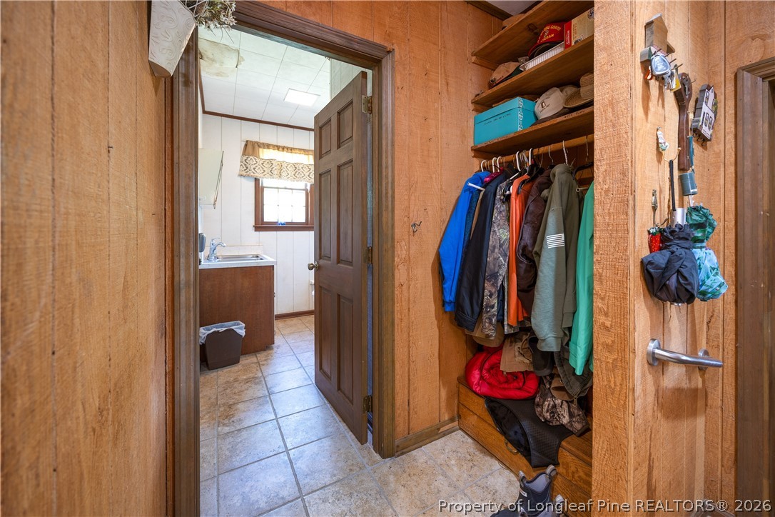 6346 Dunn Road Roseboro, NC 28382 - Photo 33 of 39 a view of walk in closet with clothes and shoes