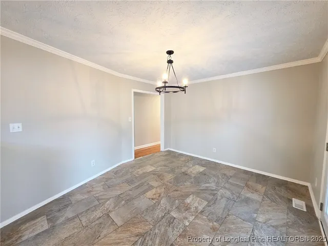 a view of a big room with a chandelier fan