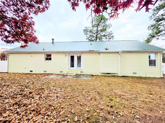 a view of a backyard with a tree