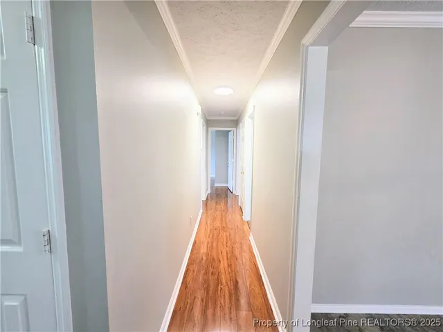 a view of a hallway with wooden floor
