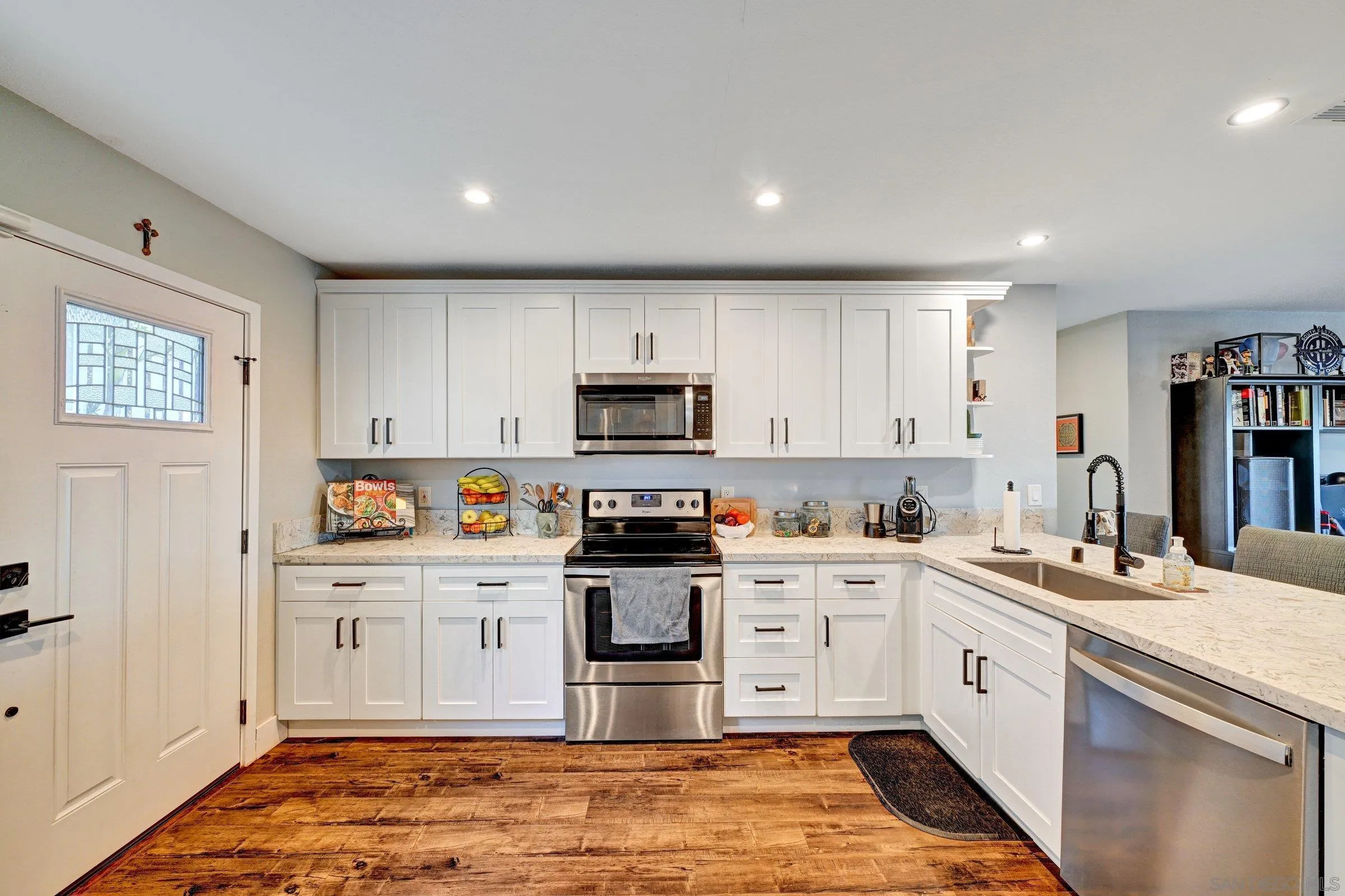 2312 Helix Street Spring Valley, CA 91977 - Photo 18 of 46 a kitchen with stainless steel appliances granite countertop a stove sink and cabinets