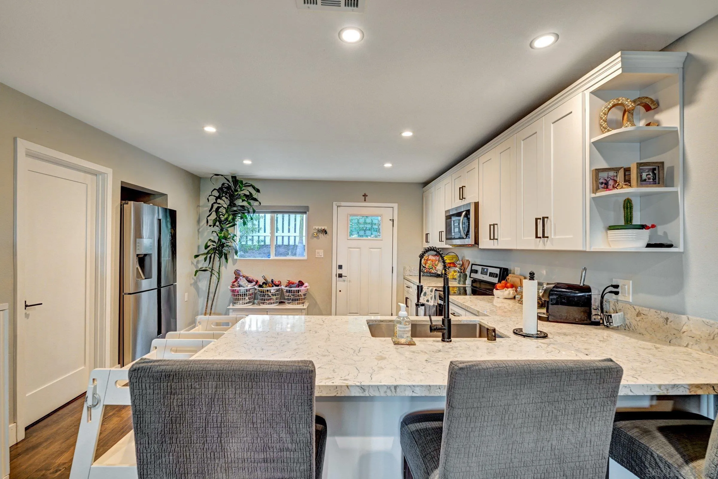 2312 Helix Street Spring Valley, CA 91977 - Photo 21 of 46 a dining hall with stainless steel appliances granite countertop a dining table and chairs