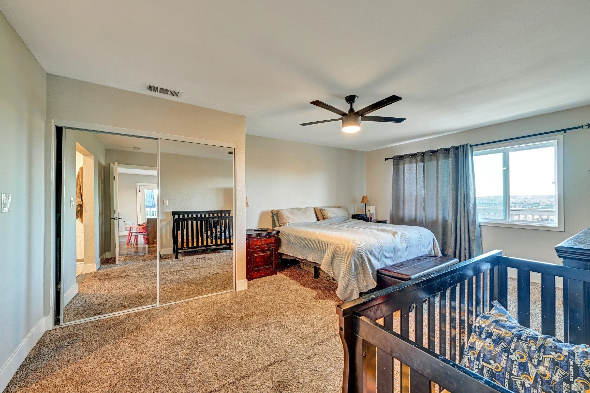 2312 Helix Street Spring Valley, CA 91977 - Photo 28 of 46 a bedroom with bed and windows