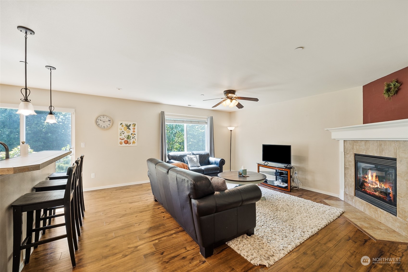 1345 Foreman Road DuPont, WA 98327 - Photo 11 of 34 a living room with furniture a fireplace and a flat screen tv
