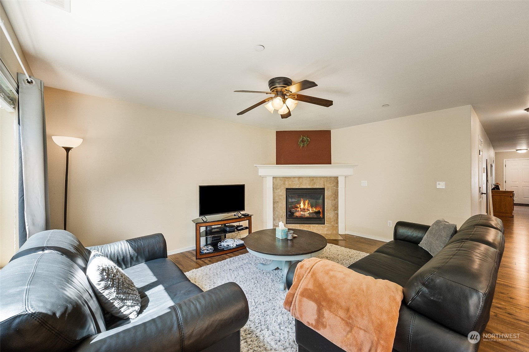 1345 Foreman Road DuPont, WA 98327 - Photo 12 of 34 a living room with furniture a fireplace and a flat screen tv