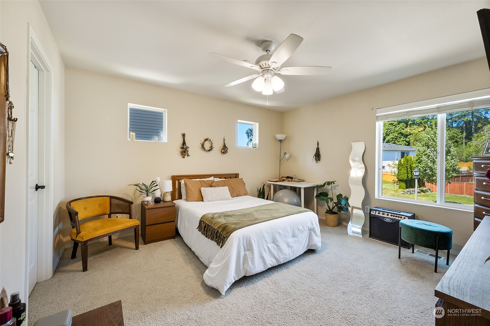 1345 Foreman Road DuPont, WA 98327 - Photo 14 of 34 a bedroom with a bed and a chandelier