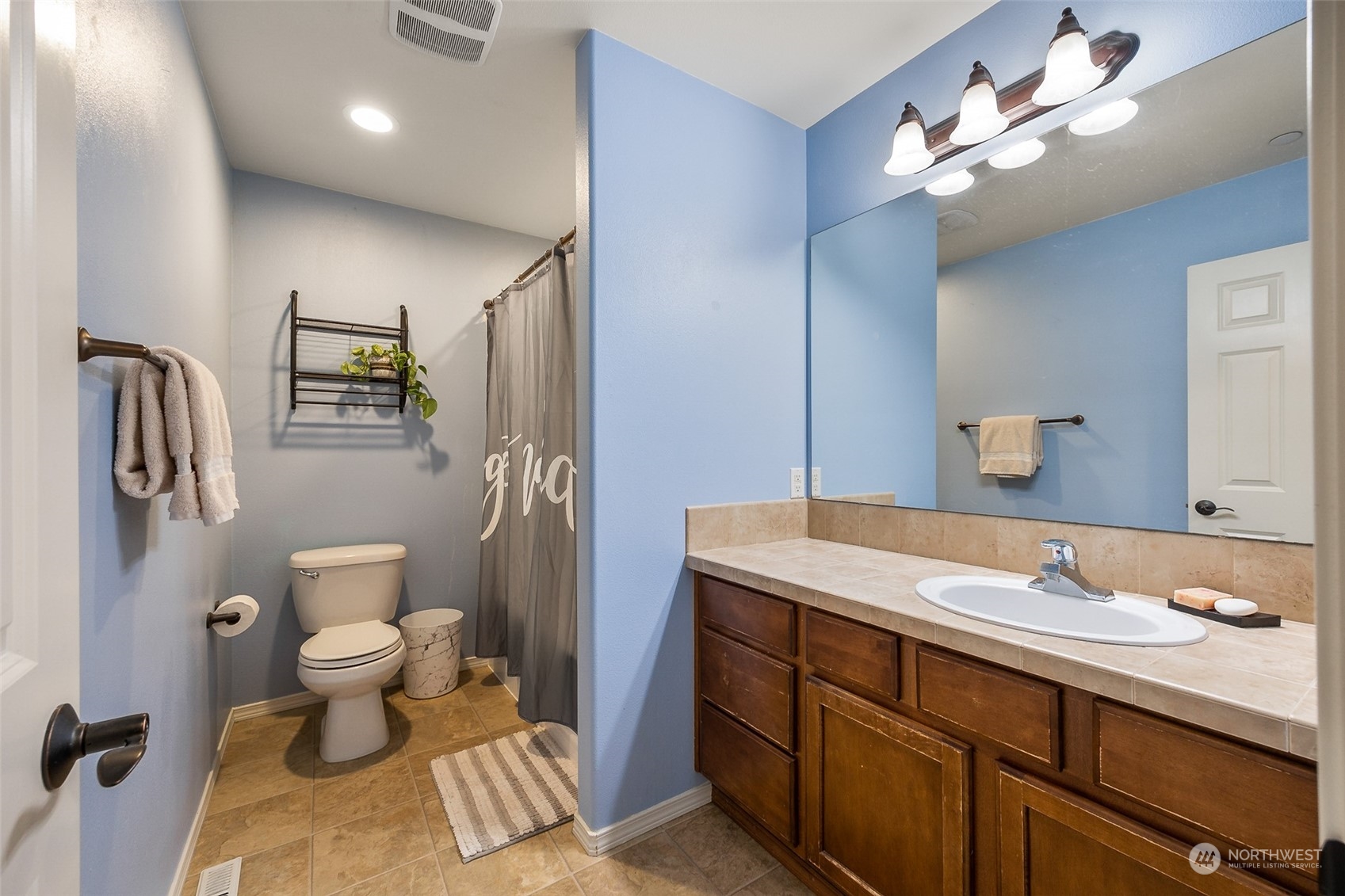 1345 Foreman Road DuPont, WA 98327 - Photo 16 of 34 a bathroom with a toilet sink and mirror