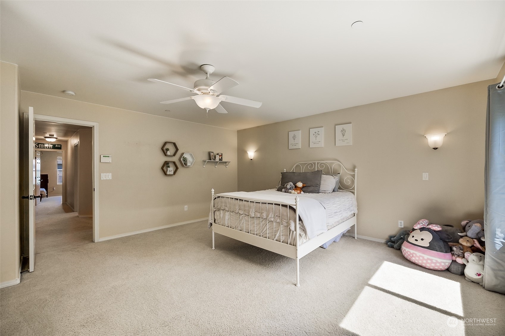 1345 Foreman Road DuPont, WA 98327 - Photo 18 of 34 a spacious bedroom with a bed and a chandelier