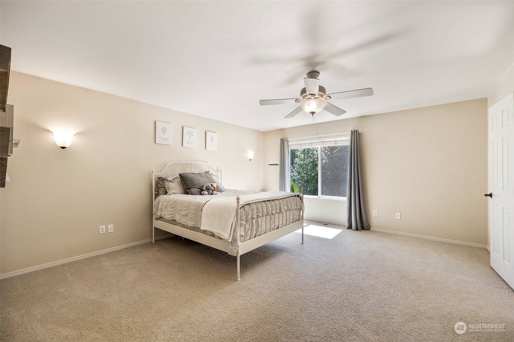 1345 Foreman Road DuPont, WA 98327 - Photo 19 of 34 a spacious bedroom with a bed and a chandelier
