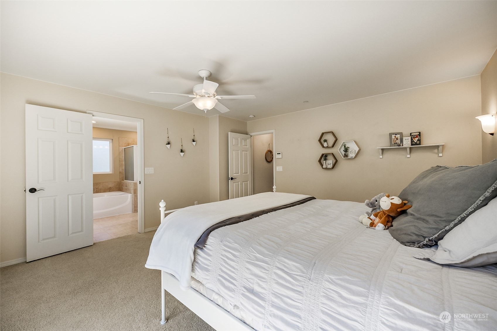 1345 Foreman Road DuPont, WA 98327 - Photo 20 of 34 a bedroom with a bed and a chandelier