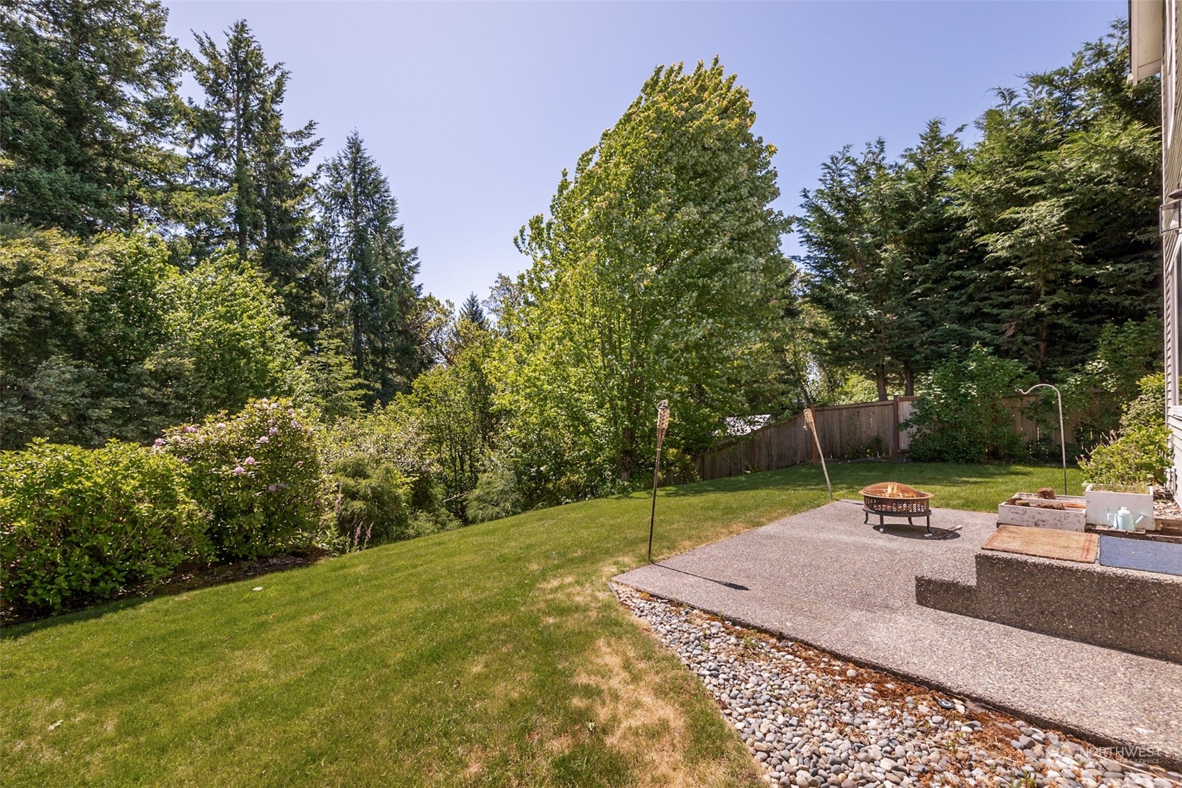 1345 Foreman Road DuPont, WA 98327 - Photo 23 of 34 a backyard of a house with fountain table and chairs