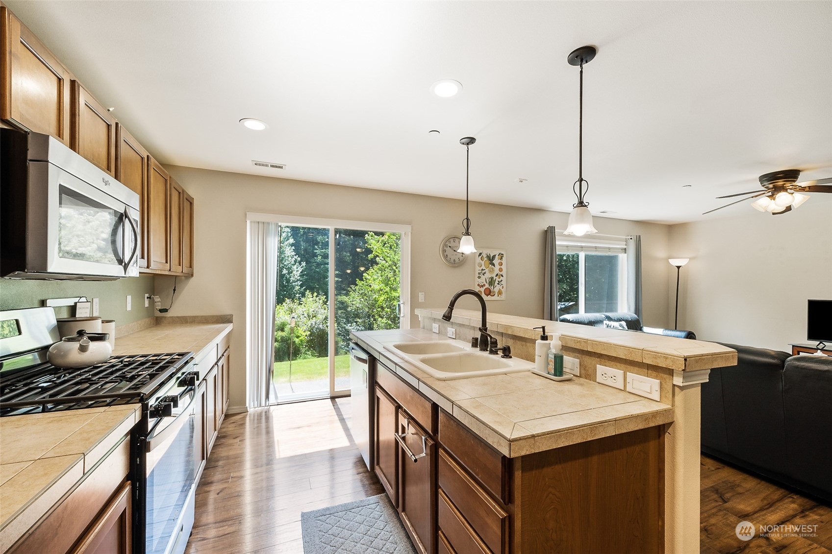 1345 Foreman Road DuPont, WA 98327 - Photo 8 of 34 a kitchen with a stove sink and microwave