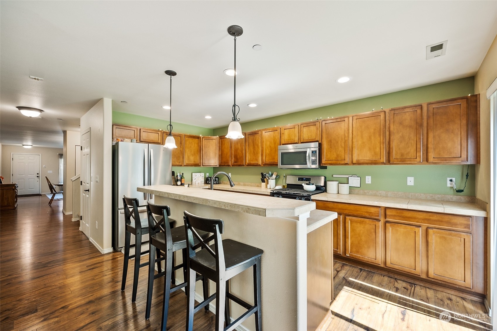 1345 Foreman Road DuPont, WA 98327 - Photo 9 of 34 a kitchen with a table chairs sink and cabinets