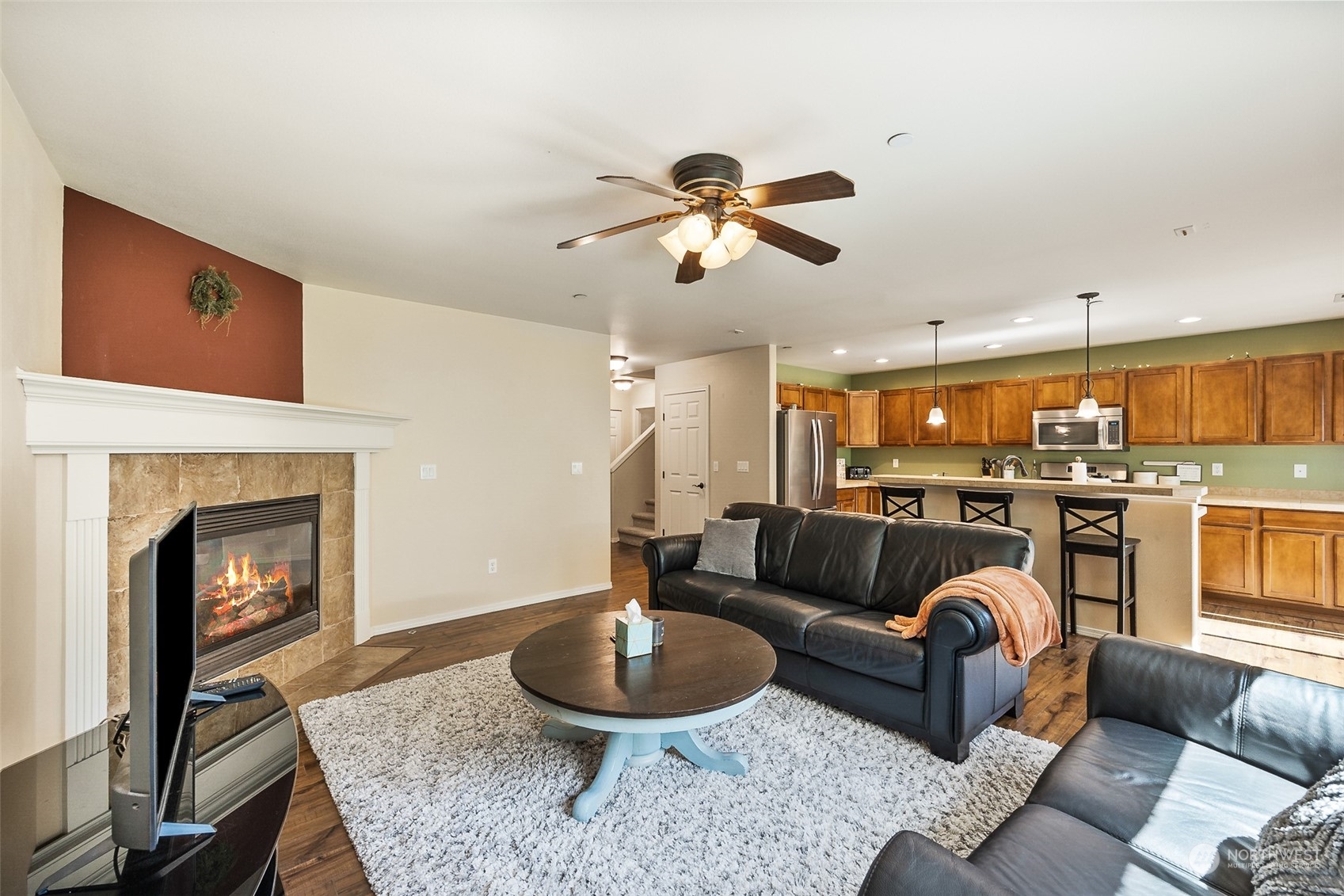 1345 Foreman Road DuPont, WA 98327 - Photo 10 of 34 a living room with furniture a fireplace and a chandelier