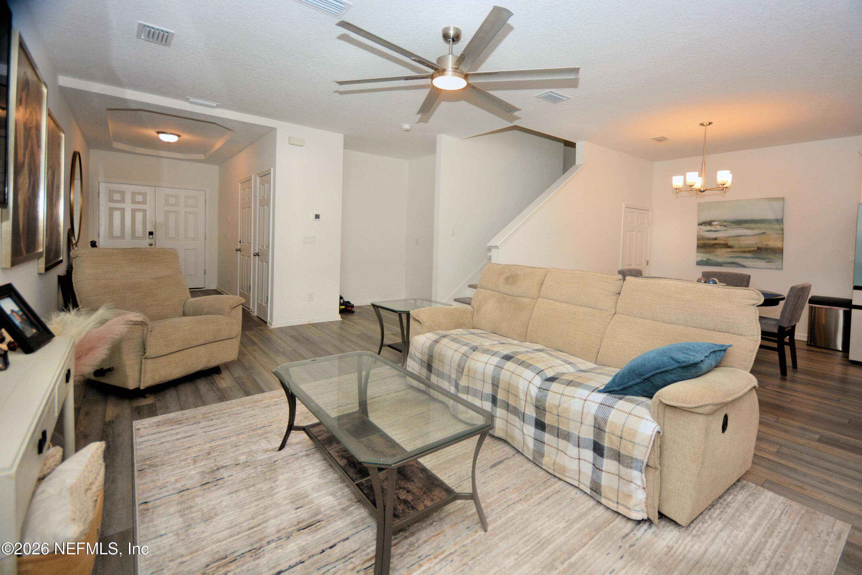 1688 Sanctuary Way Fleming Island, FL 32003 - Photo 16 of 35 a living room with furniture and a wooden floor