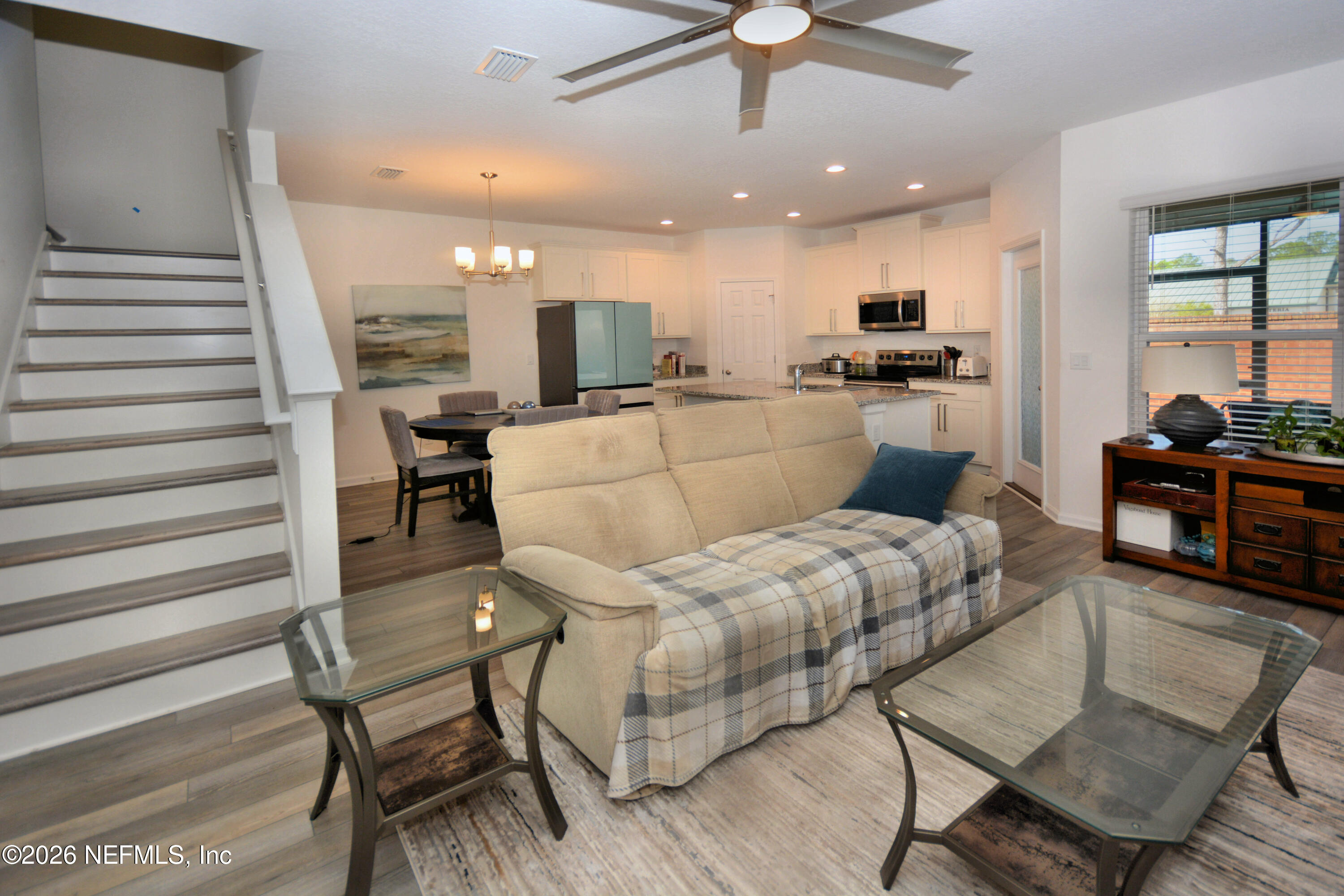 1688 Sanctuary Way Fleming Island, FL 32003 - Photo 17 of 35 a living room with furniture and kitchen view