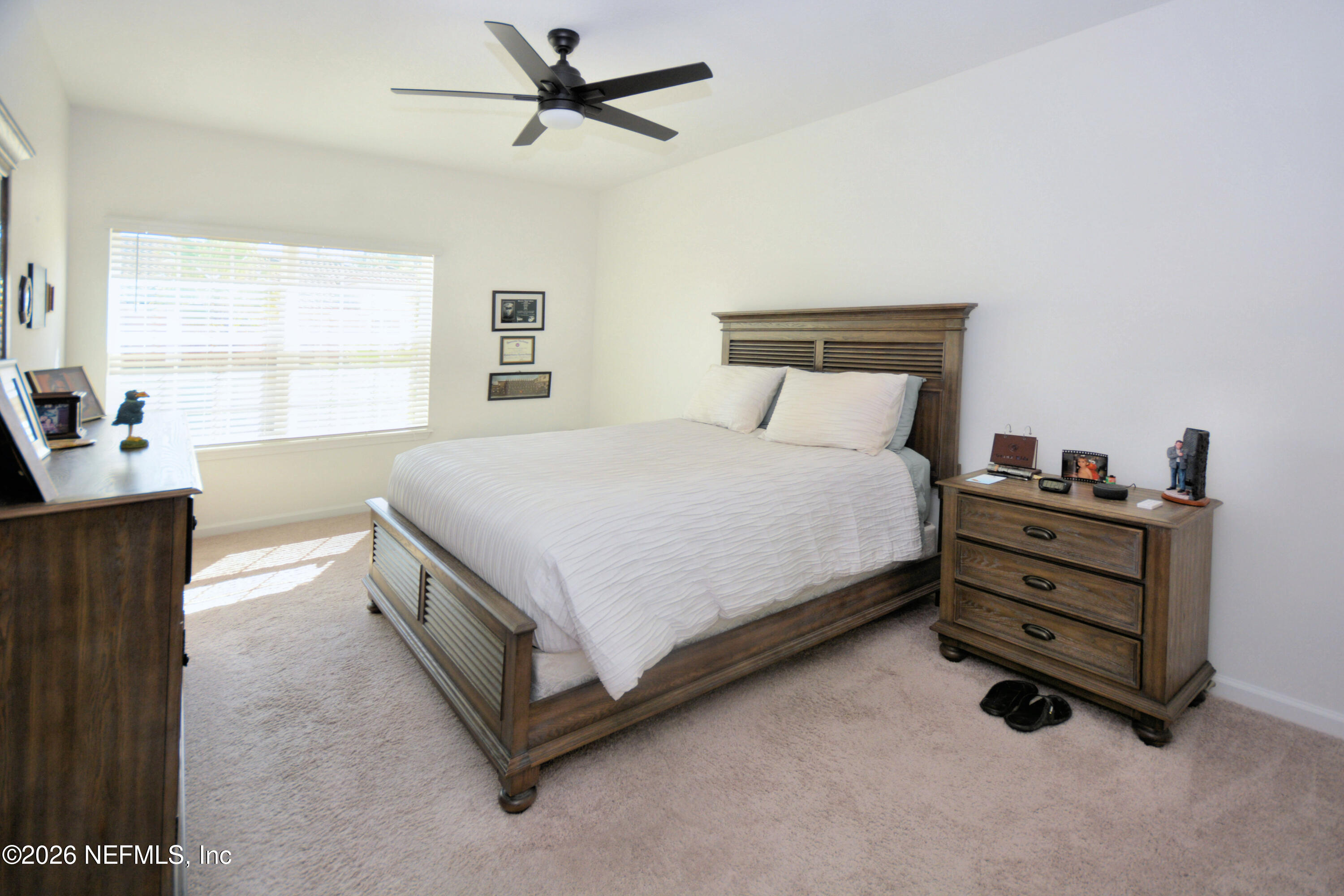 1688 Sanctuary Way Fleming Island, FL 32003 - Photo 20 of 35 a spacious bedroom with a bed and a window