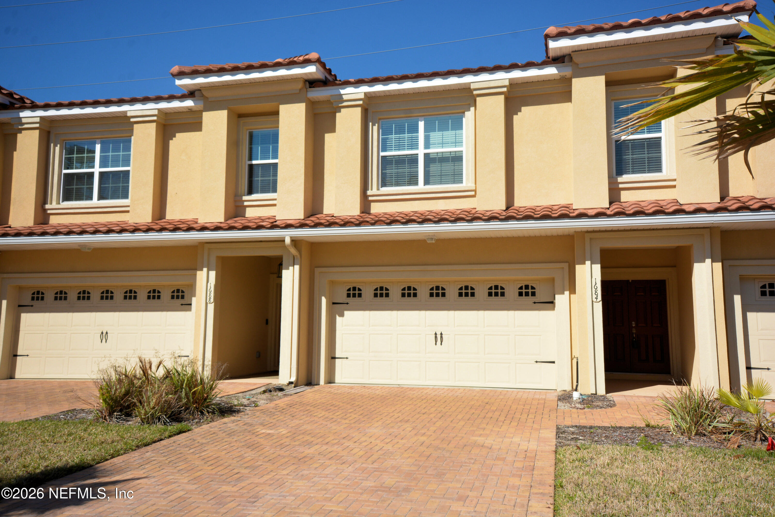 1688 Sanctuary Way Fleming Island, FL 32003 - Photo 2 of 35 a front view of a house with a yard and garage