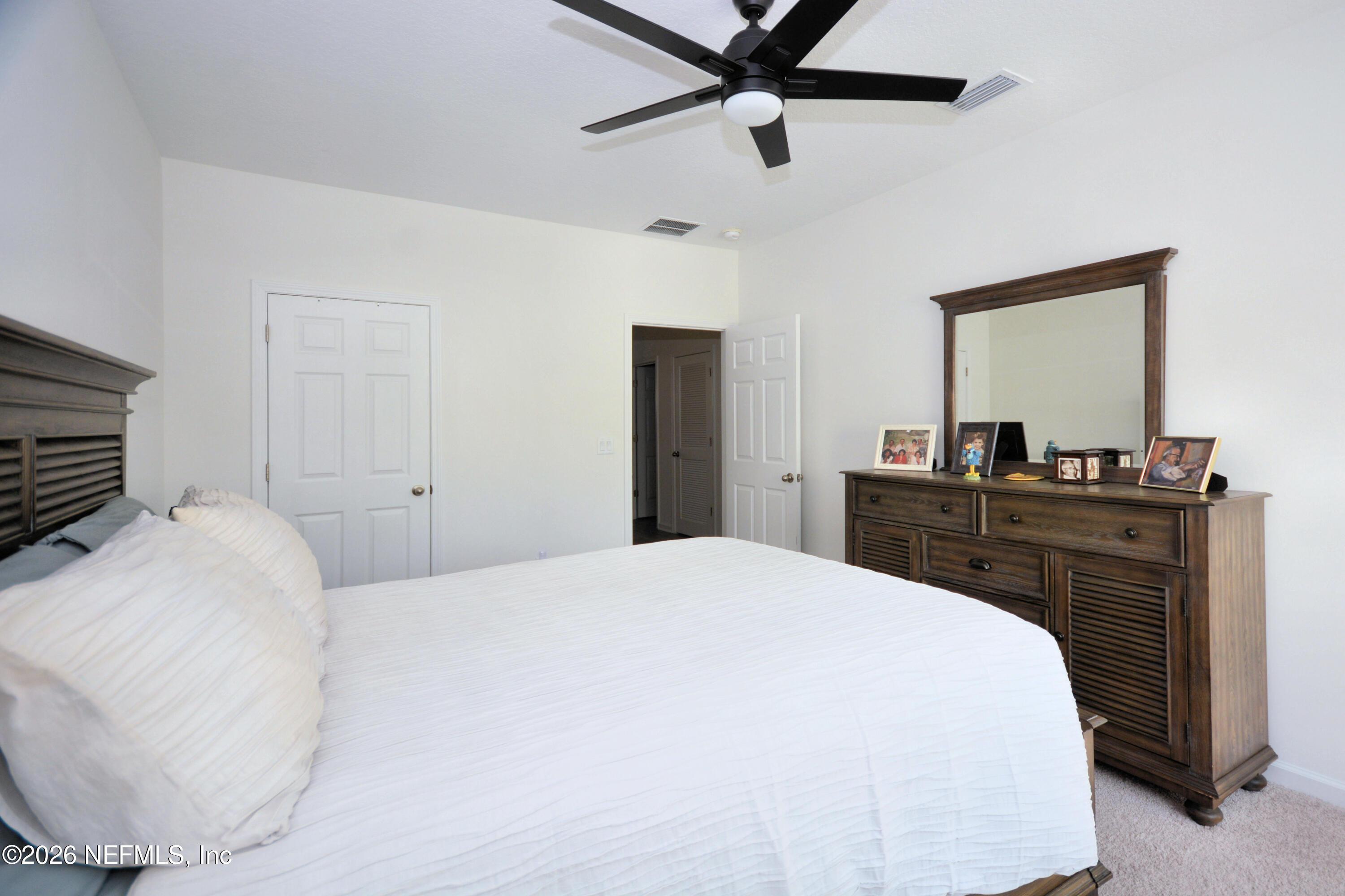 1688 Sanctuary Way Fleming Island, FL 32003 - Photo 22 of 35 a bedroom with a bed and a dresser