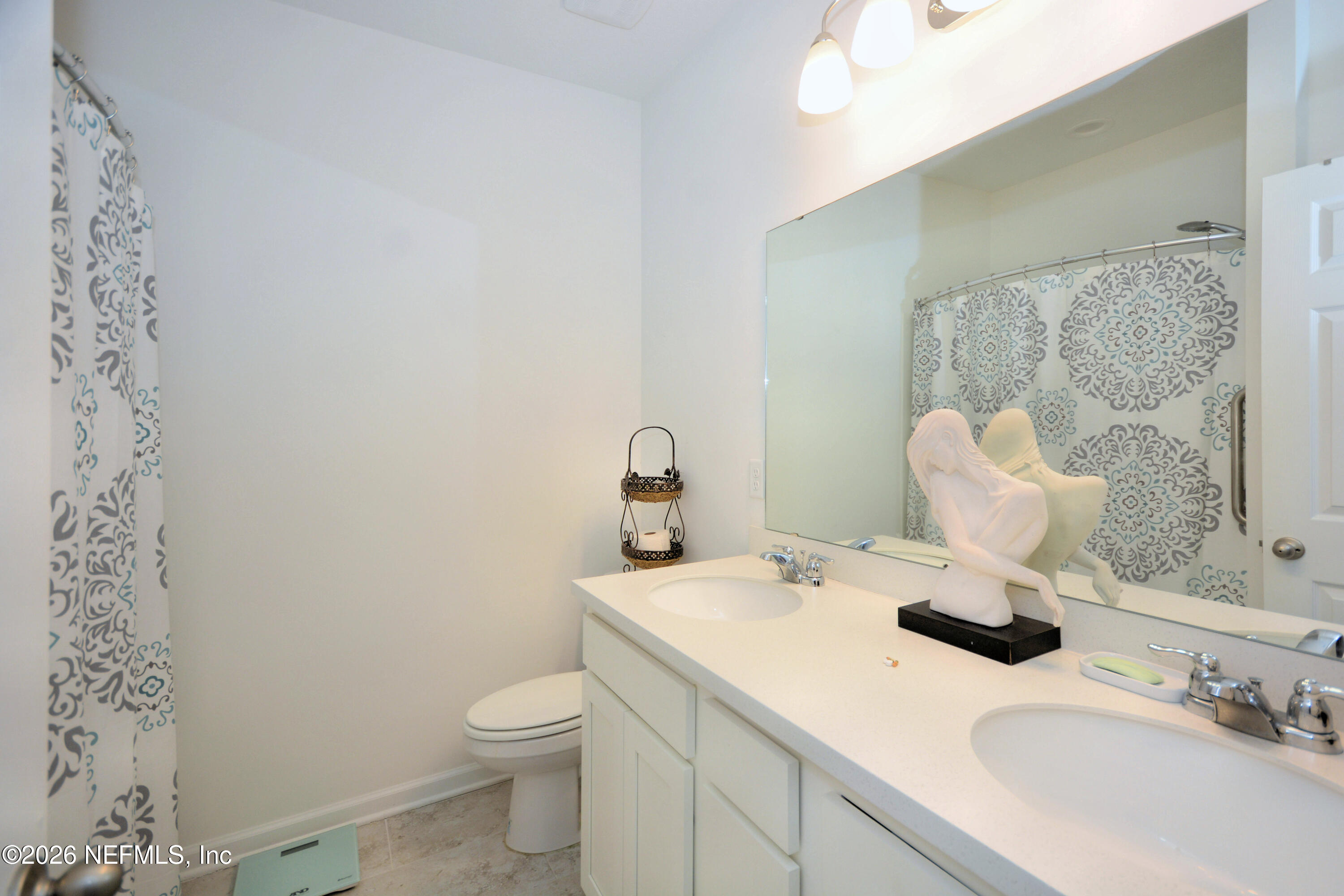 1688 Sanctuary Way Fleming Island, FL 32003 - Photo 24 of 35 a bathroom with a sink vanity and toilet