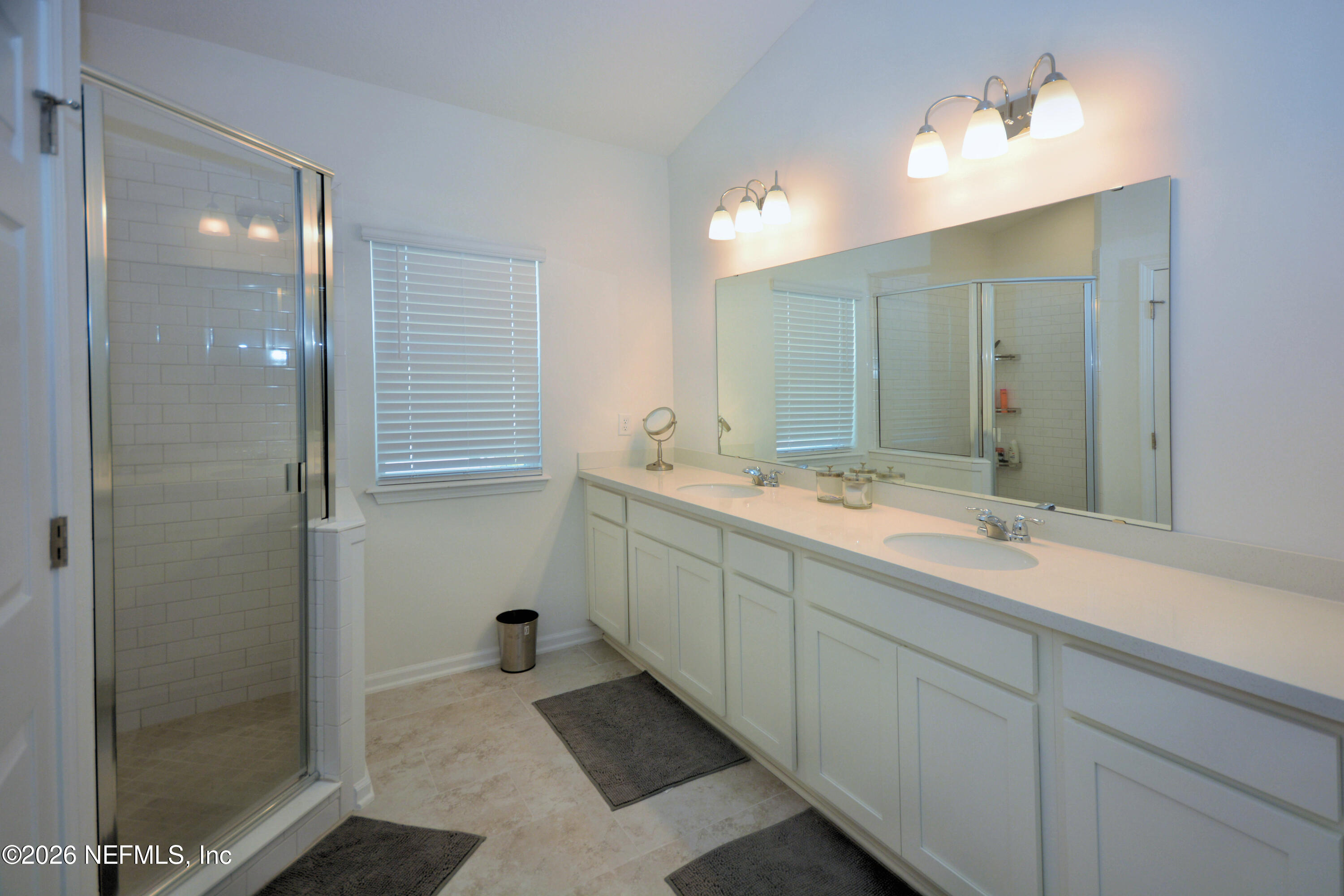 1688 Sanctuary Way Fleming Island, FL 32003 - Photo 26 of 35 a bathroom with a double vanity sink mirror and shower