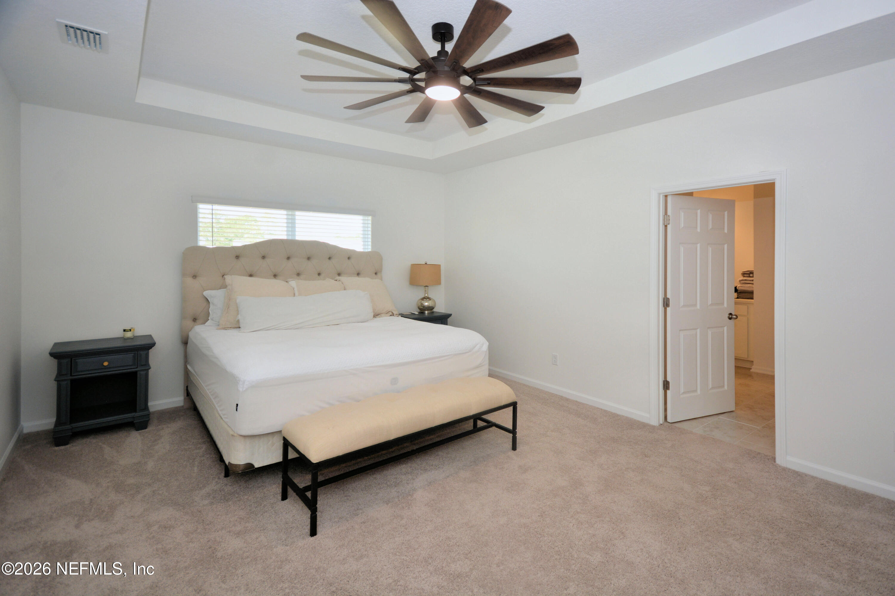 1688 Sanctuary Way Fleming Island, FL 32003 - Photo 29 of 35 a bed room with a bed and a ceiling fan