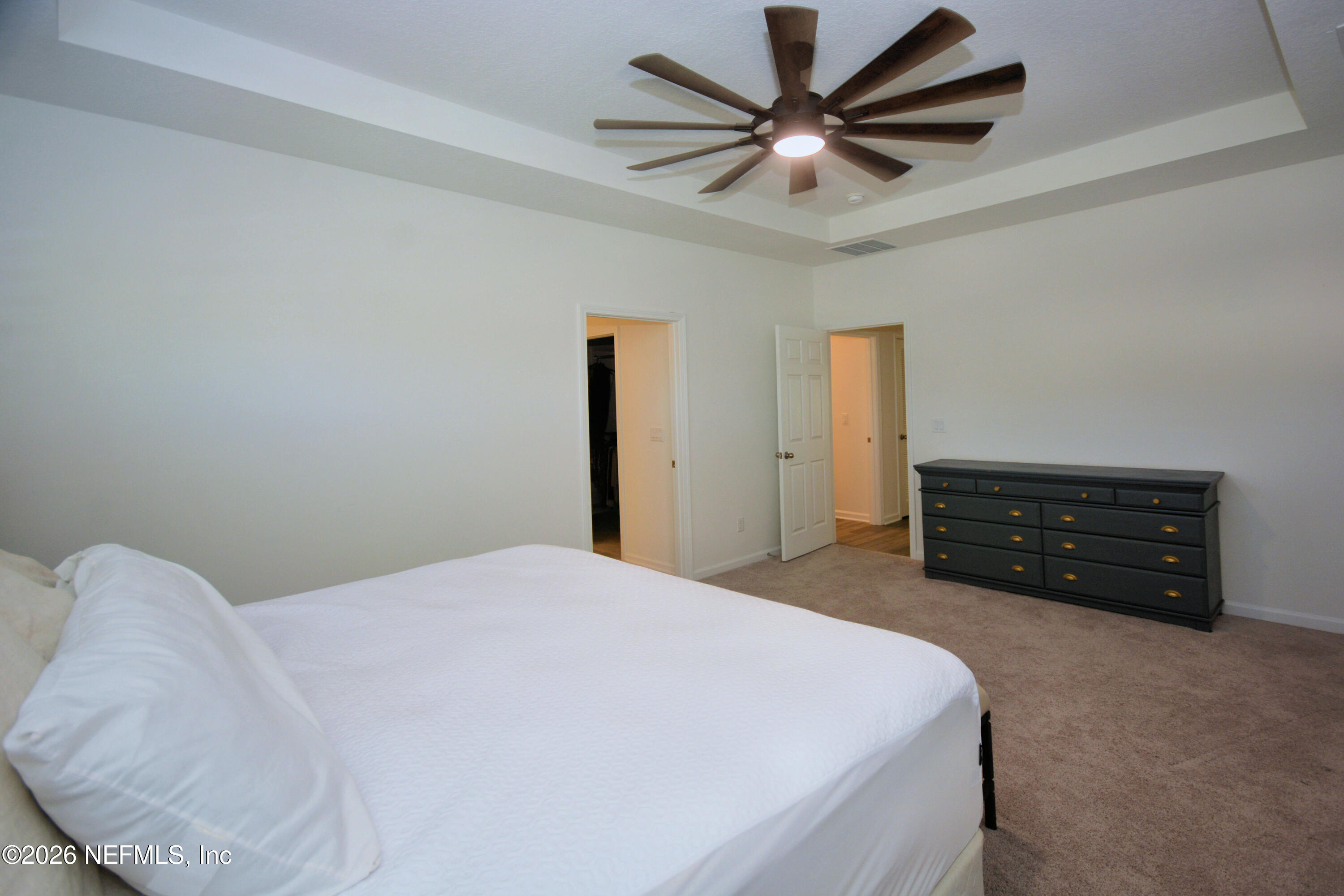 1688 Sanctuary Way Fleming Island, FL 32003 - Photo 30 of 35 a bedroom with a bed and a dresser