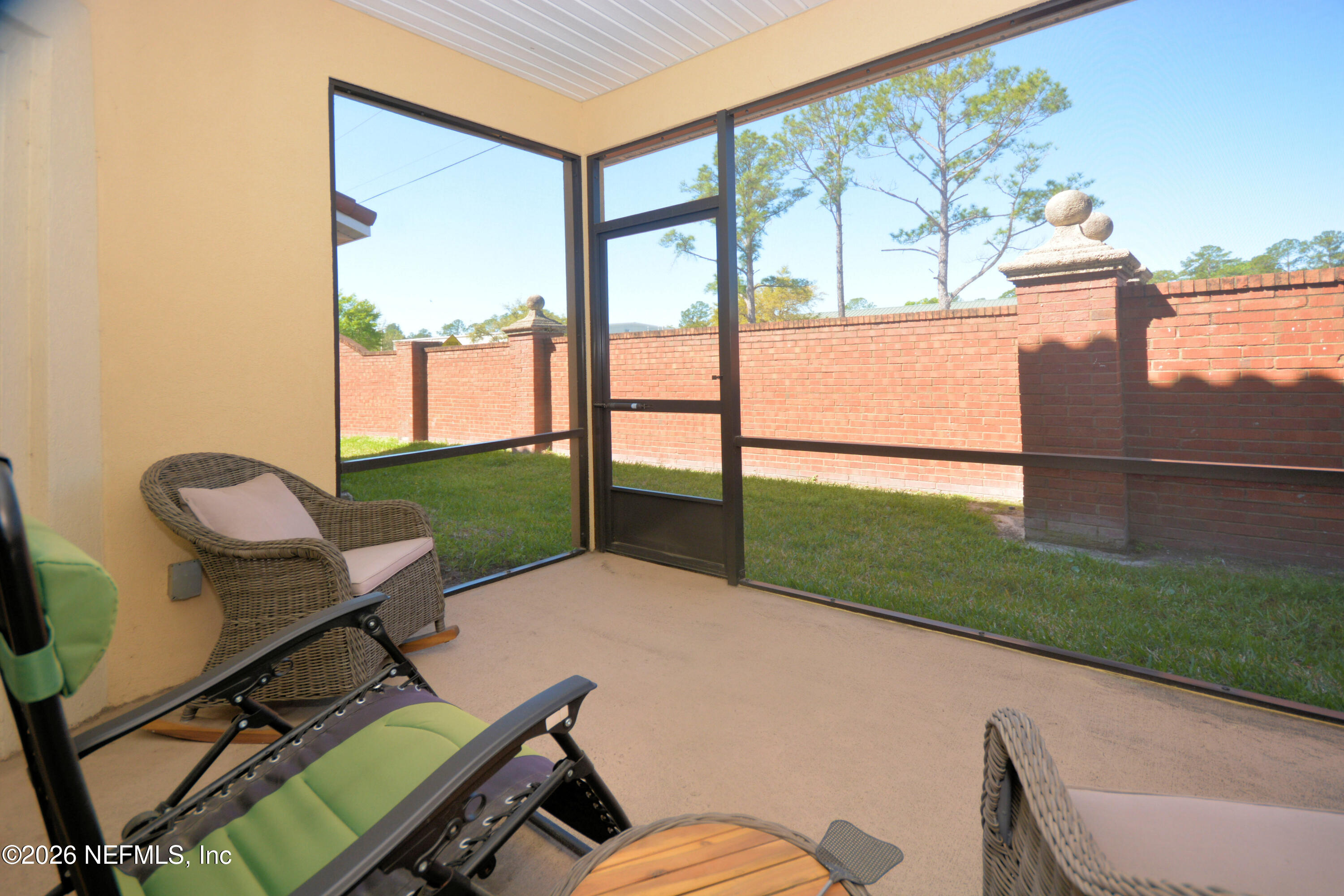 1688 Sanctuary Way Fleming Island, FL 32003 - Photo 32 of 35 a porch with a bench sitting next to a yard
