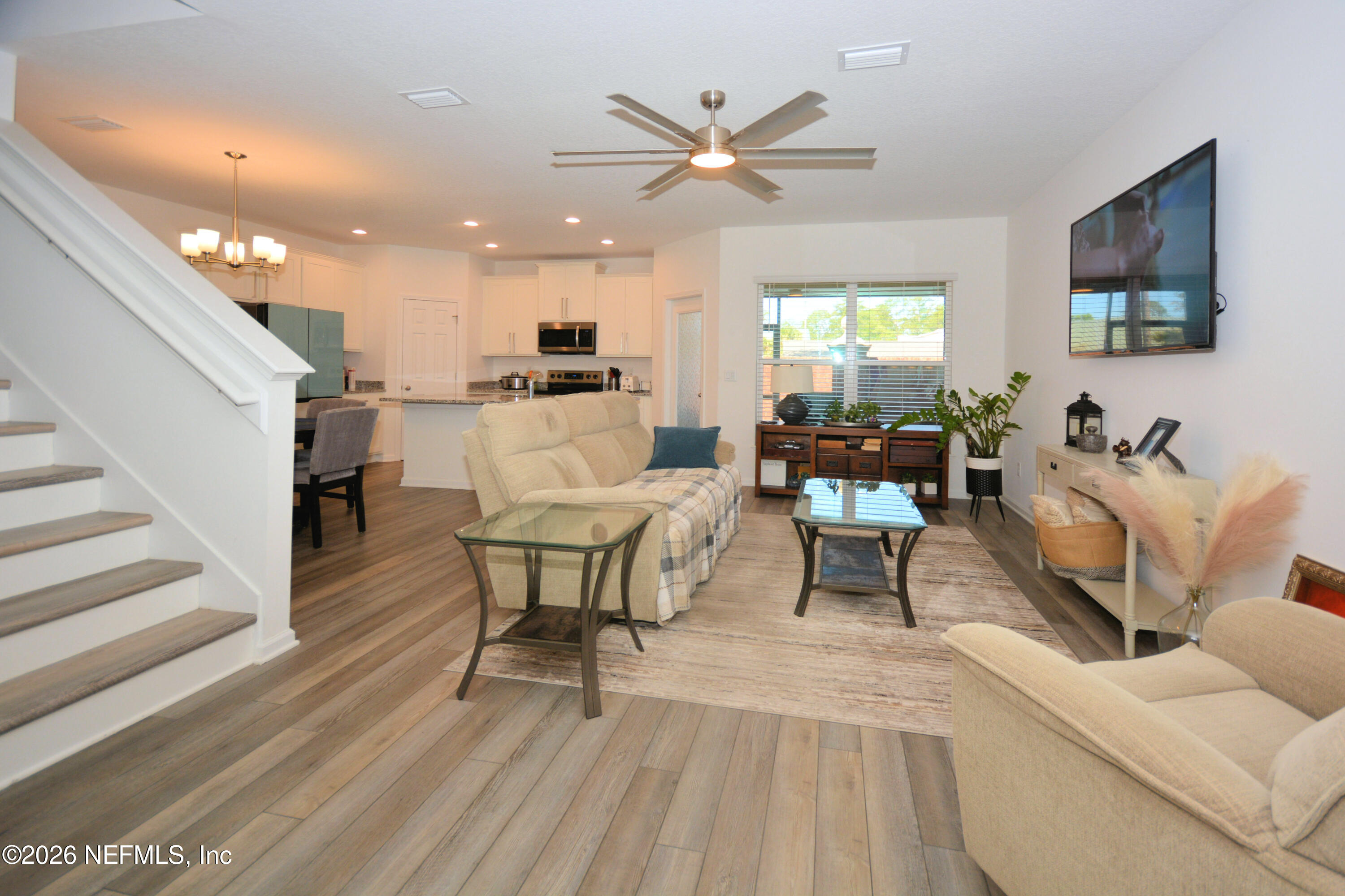 1688 Sanctuary Way Fleming Island, FL 32003 - Photo 5 of 35 a living room with furniture and a wooden floor