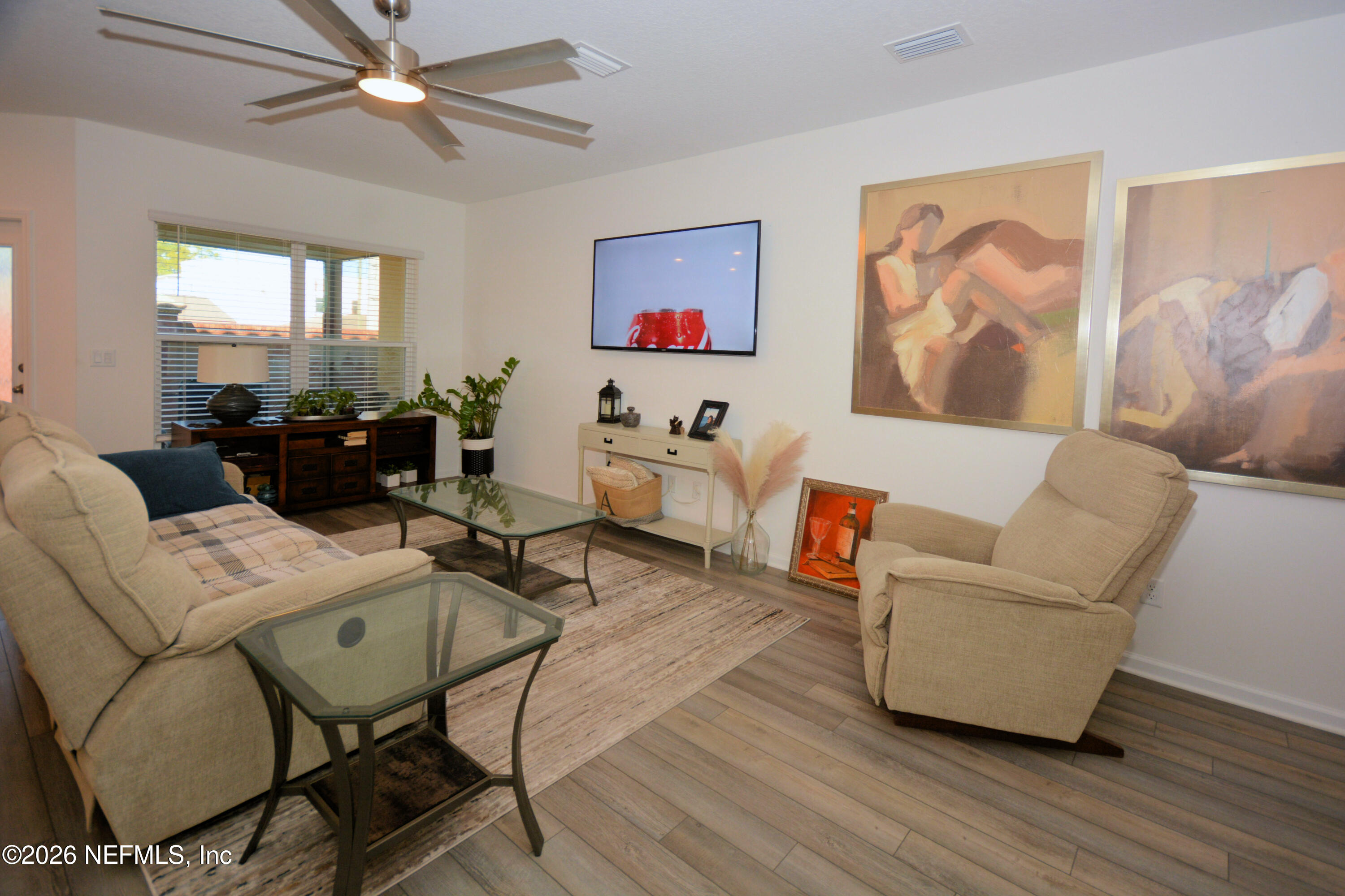 1688 Sanctuary Way Fleming Island, FL 32003 - Photo 6 of 35 a living room with furniture and wooden floor