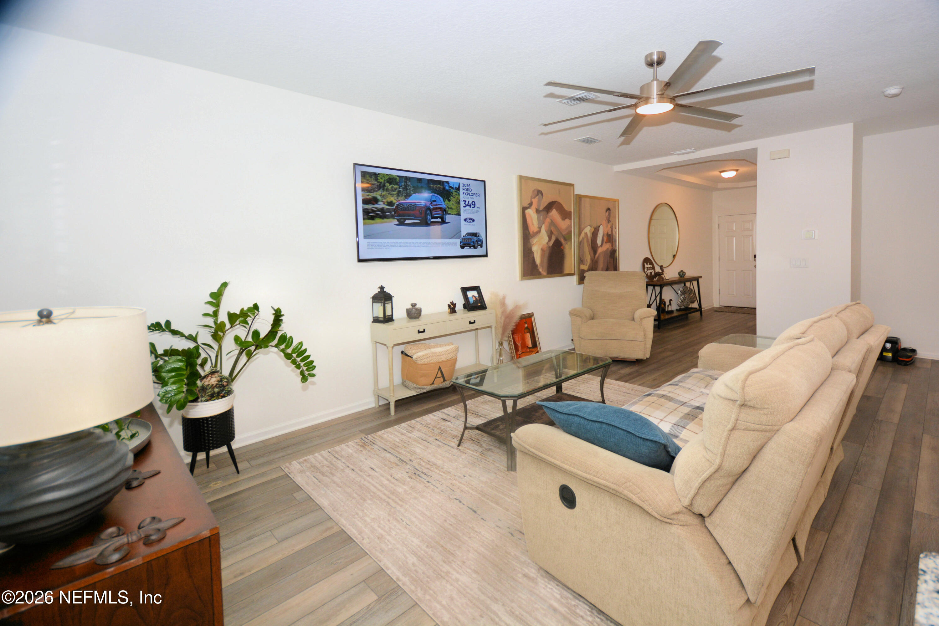 1688 Sanctuary Way Fleming Island, FL 32003 - Photo 8 of 35 a living room with furniture and wooden floor
