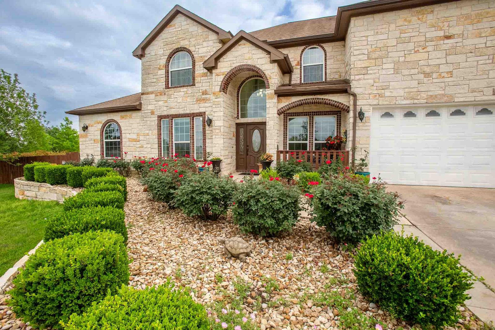 323 Woodbrook Trail Buda, TX 78610 - Photo 2 of 40 Beautiful exterior featuring arched window details and a two-car garage