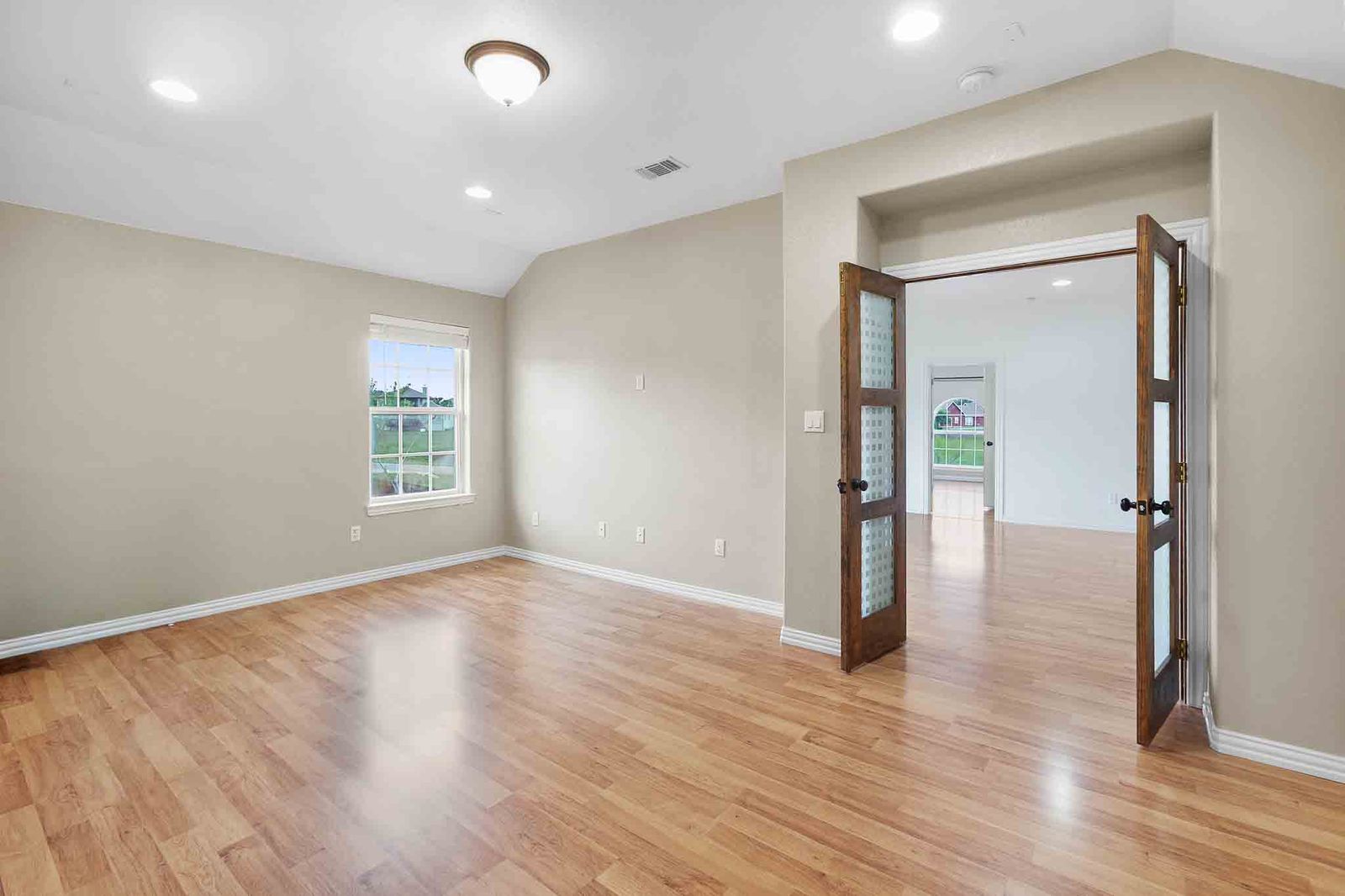 323 Woodbrook Trail Buda, TX 78610 - Photo 26 of 40 Media room featuring wood-finish flooring, recessed lighting, and a window with white trim