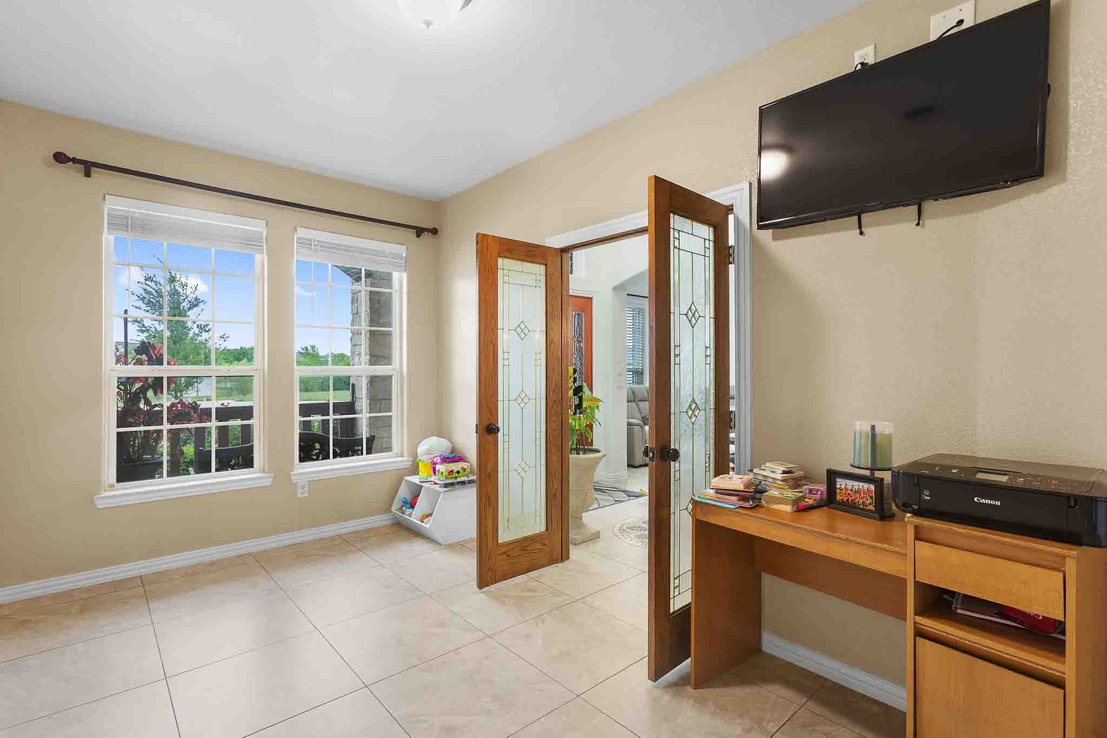 323 Woodbrook Trail Buda, TX 78610 - Photo 29 of 40 Office featuring tile flooring, two large windows with white blinds, and double French doors with decorative glass inserts