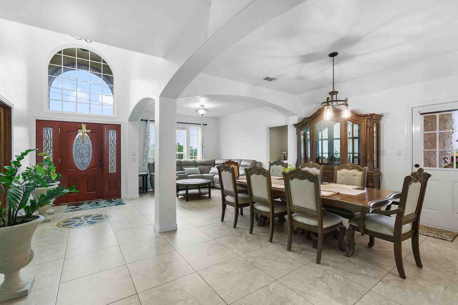 323 Woodbrook Trail Buda, TX 78610 - Photo 3 of 40 Two-story entryway with a decorative wooden front door featuring an arched transom window and sidelights