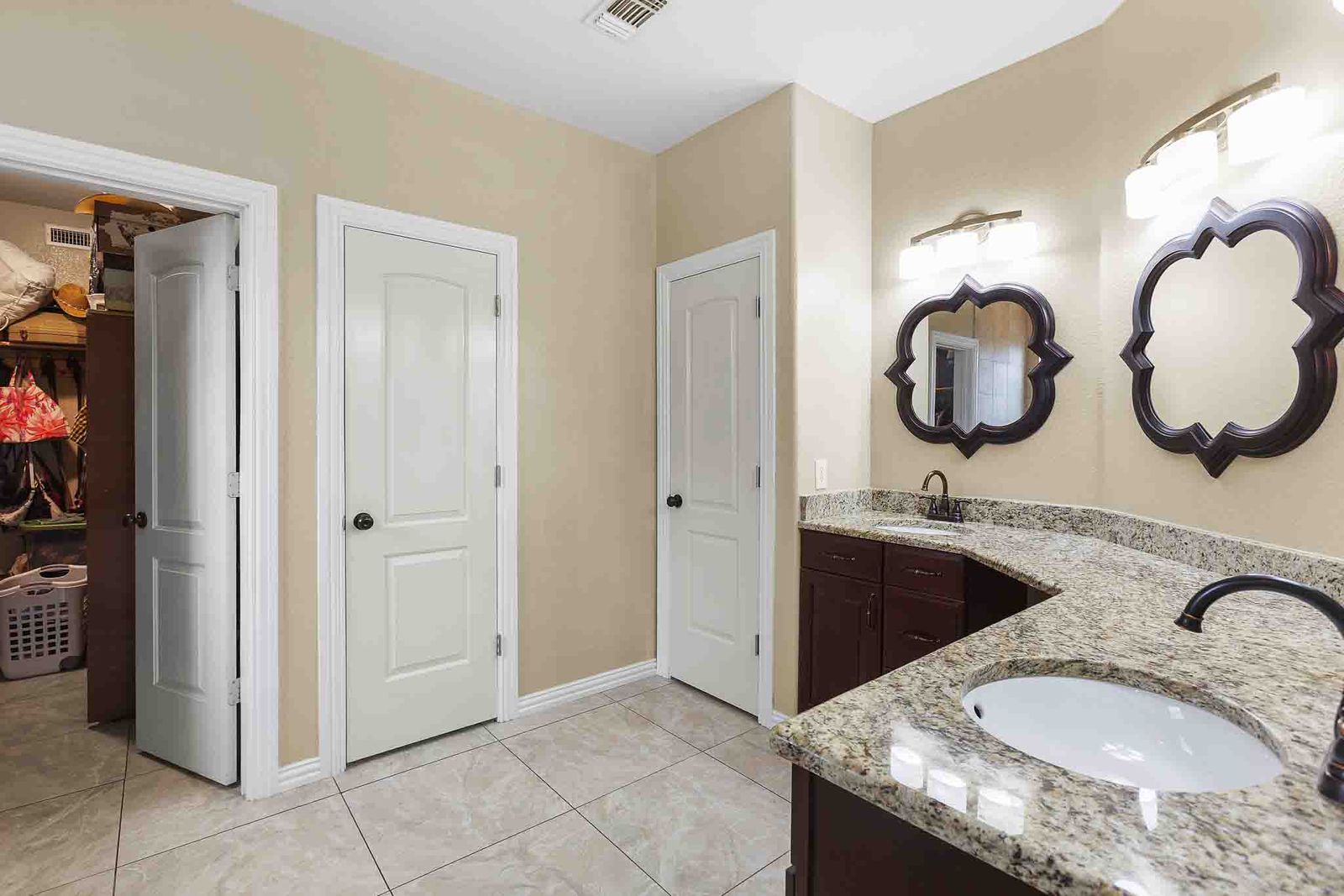323 Woodbrook Trail Buda, TX 78610 - Photo 35 of 40 Primary bathroom featuring a walk-in glass shower, jacuzzi, a double vanity with granite countertop, and tile flooring