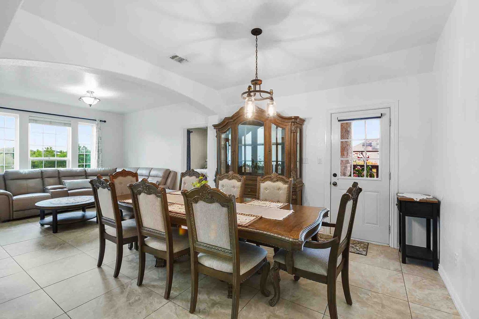 323 Woodbrook Trail Buda, TX 78610 - Photo 4 of 40 Open-concept dining area featuring light-colored tile flooring and white walls