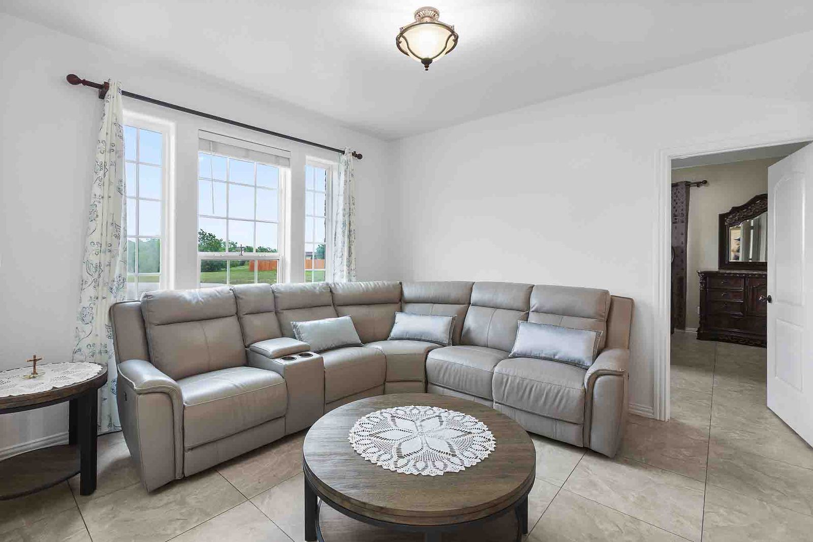 323 Woodbrook Trail Buda, TX 78610 - Photo 5 of 40 Entry area with light-toned tile flooring, white walls, and a multi-paned window providing natural illumination