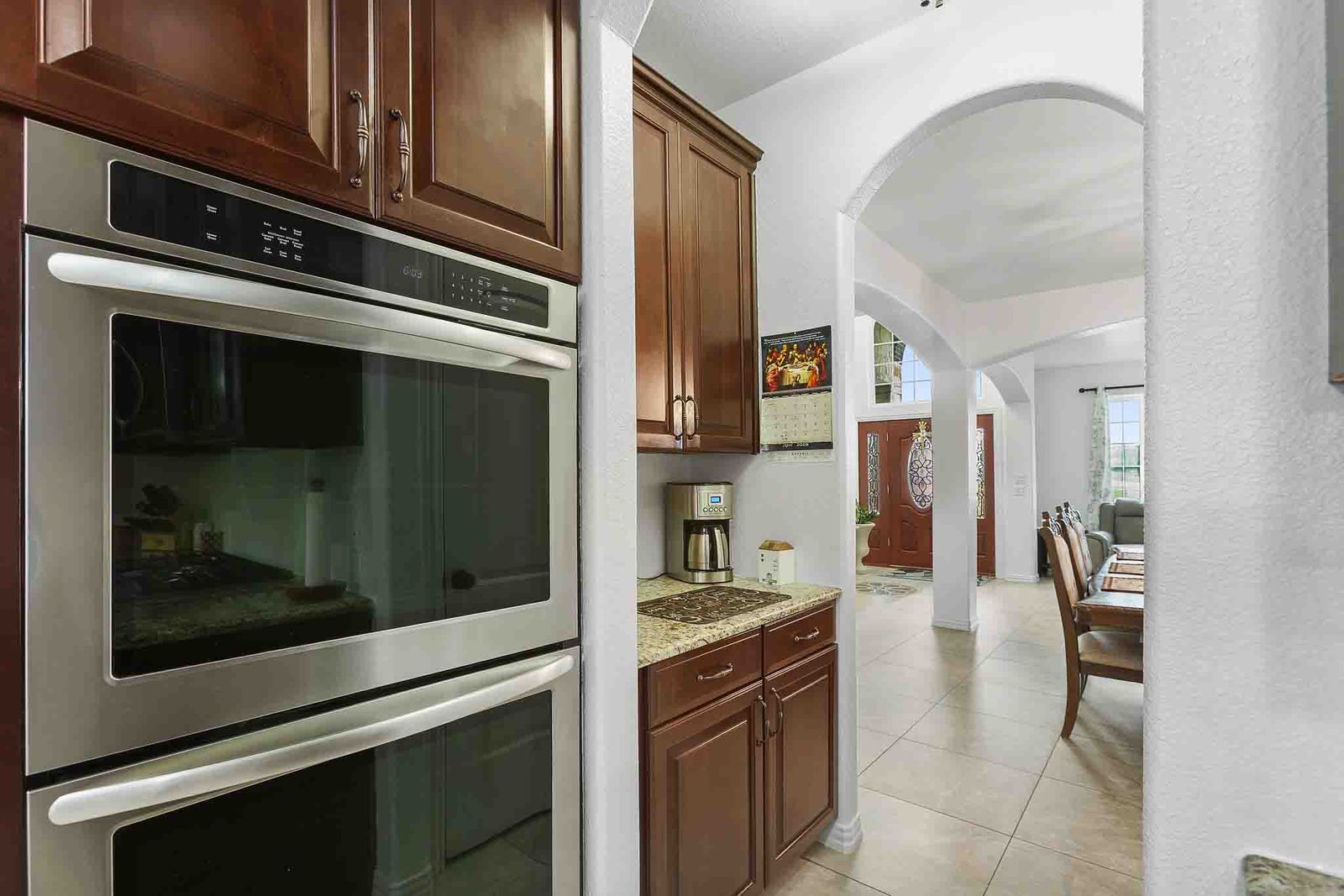 323 Woodbrook Trail Buda, TX 78610 - Photo 7 of 40 Stainless steel double wall ovens with rich wood cabinetry and dedicated coffee bar.