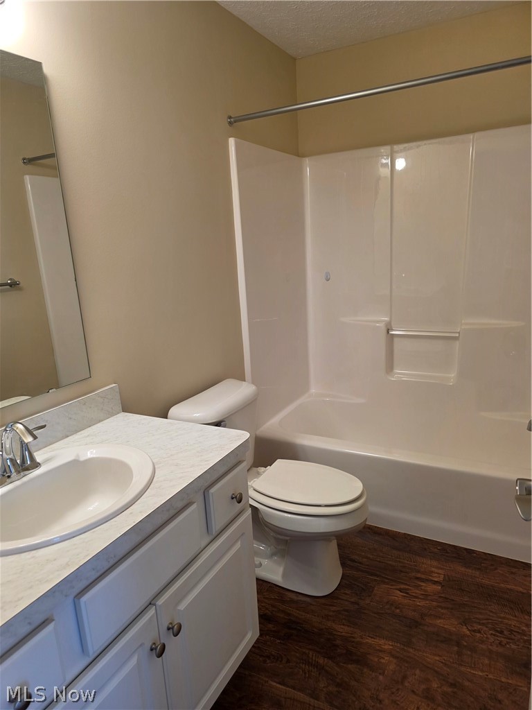 9889 Johnnycake Ridge Road, Unit B Mentor, OH 44060 - Photo 7 of 7 Bathroom featuring a white vanity with a laminate countertop, undermount sink, and chrome faucet