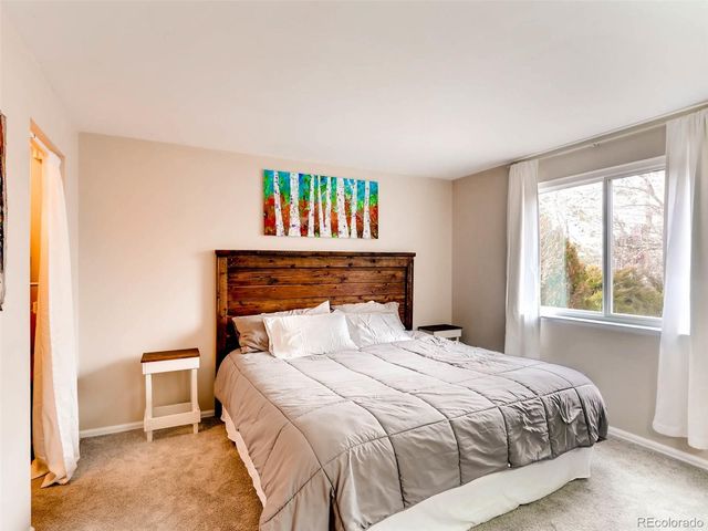 a bedroom with a bed and a large window