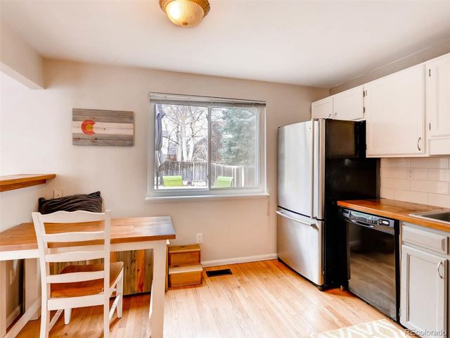 a kitchen with stainless steel appliances a refrigerator and a stove top oven