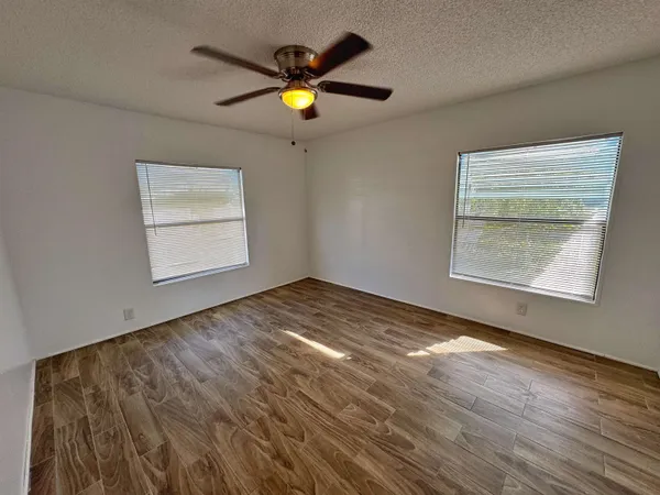 a bedroom with a bed and a chandelier fan