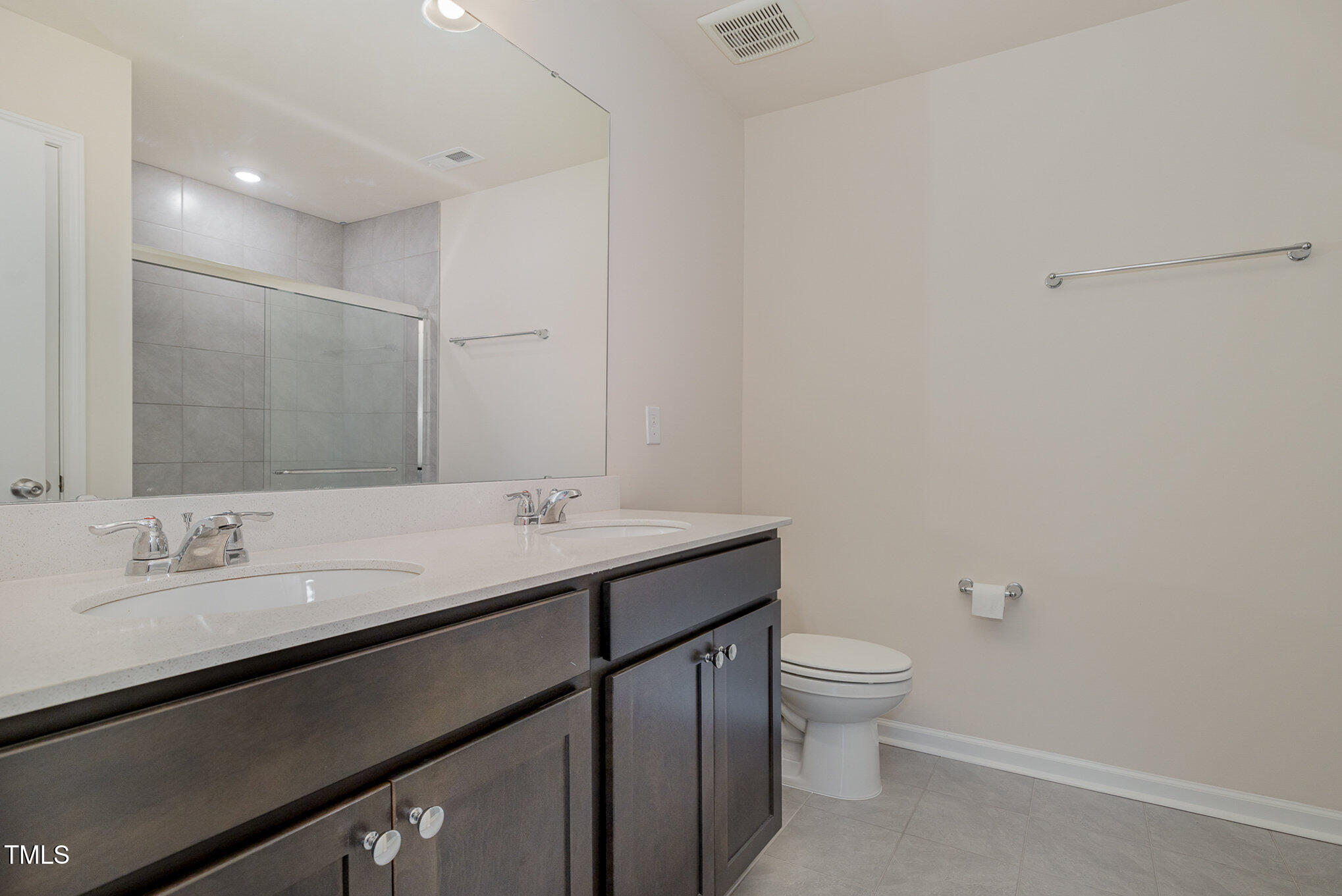 5706 Kalamata Drive Raleigh, NC 27603 - Photo 16 of 25 a bathroom with a granite countertop sink a toilet and a mirror