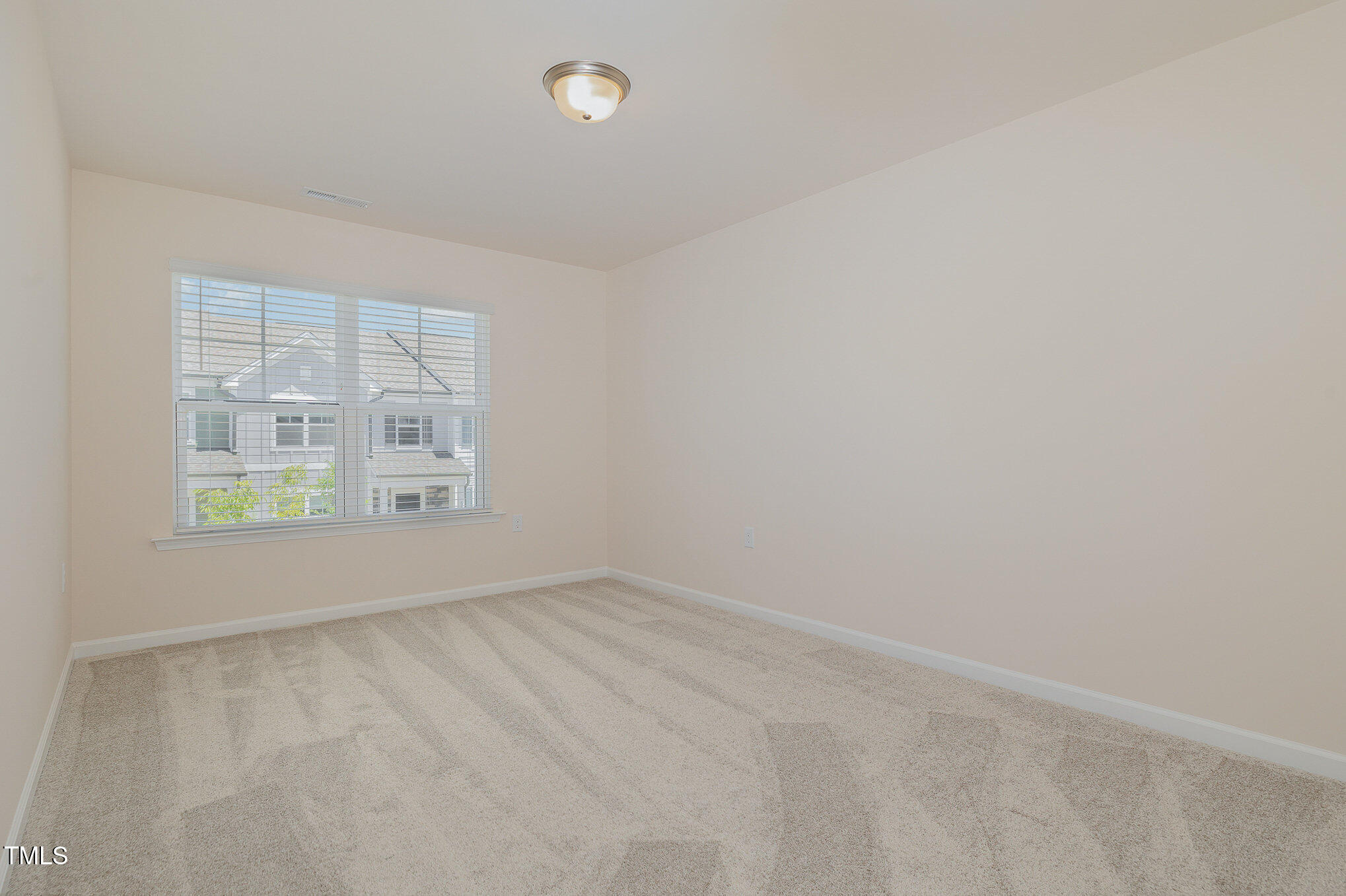 5706 Kalamata Drive Raleigh, NC 27603 - Photo 17 of 25 an empty room with windows