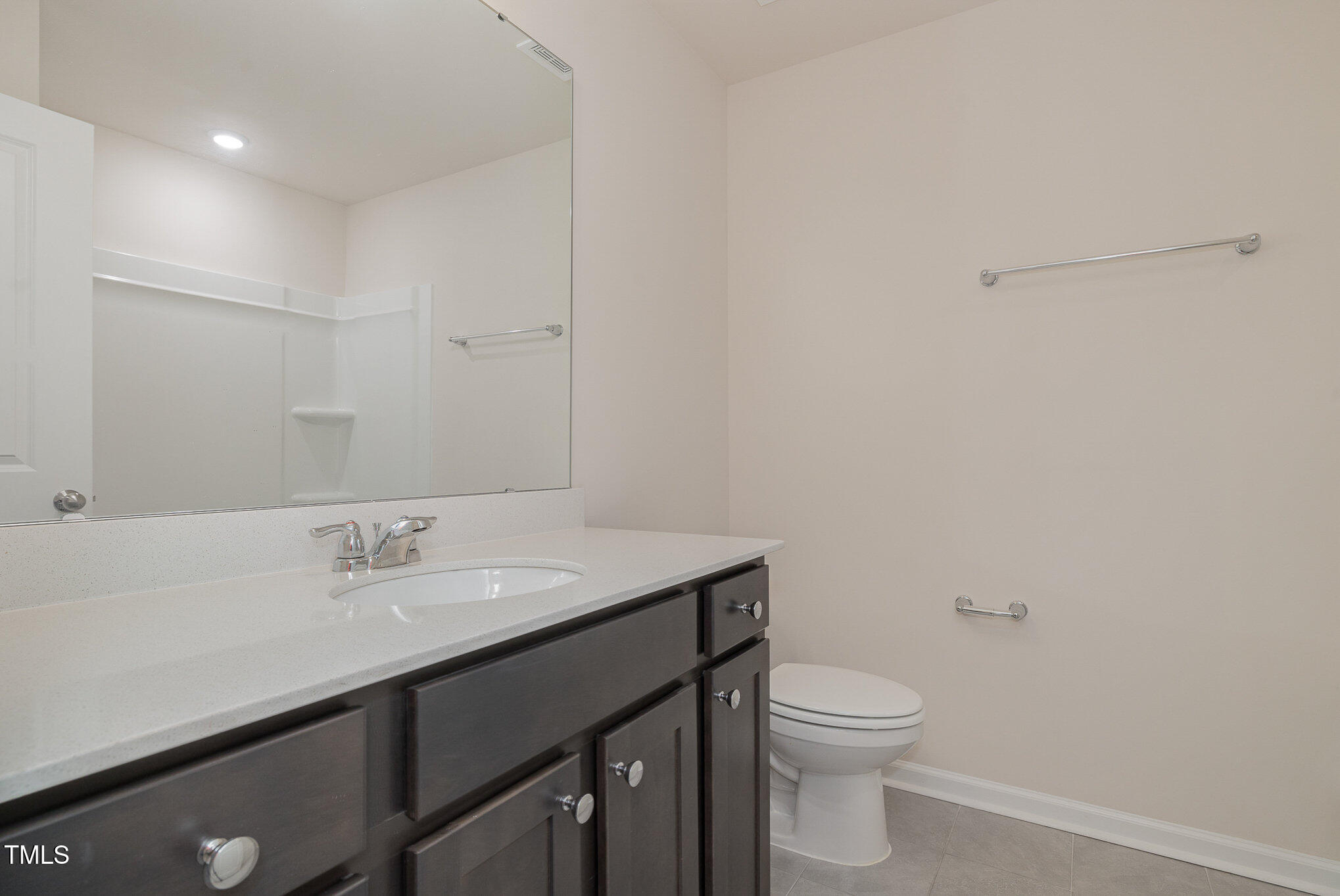 5706 Kalamata Drive Raleigh, NC 27603 - Photo 22 of 25 a bathroom with a sink a toilet and a mirror