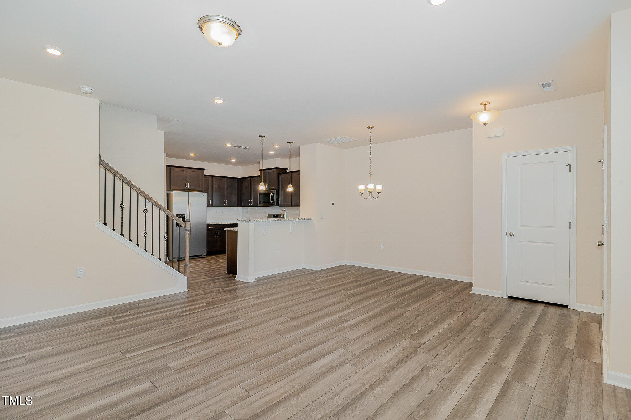 5706 Kalamata Drive Raleigh, NC 27603 - Photo 8 of 25 a view of empty room with wooden floor and windows