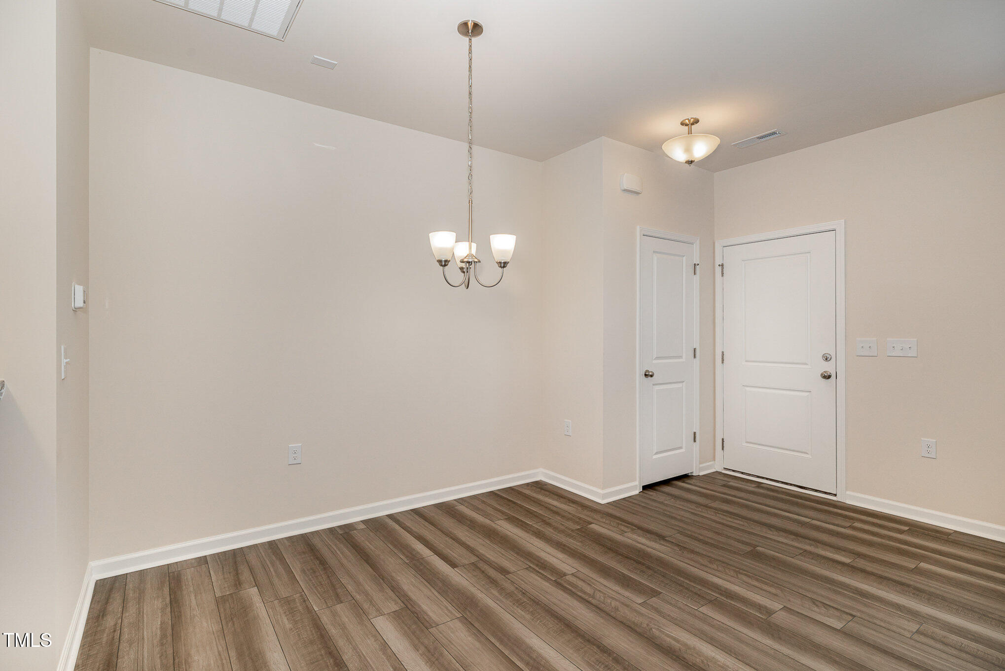 5706 Kalamata Drive Raleigh, NC 27603 - Photo 9 of 25 a view of empty room with wooden floor and ceiling fan