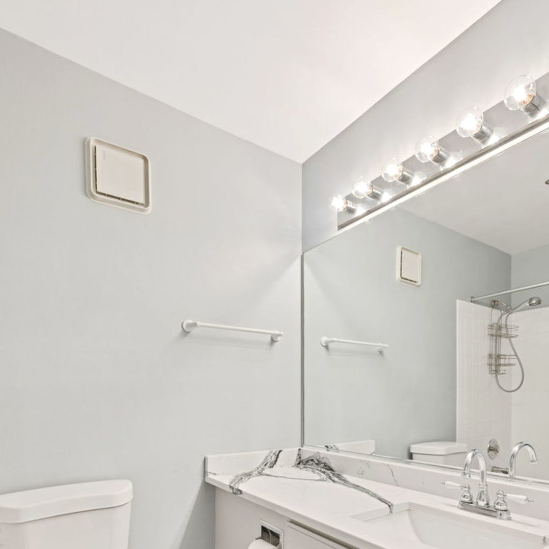 3265 Kirchoff Road, Unit 115 Rolling Meadows, IL 60008 - Photo 13 of 19 a bathroom with a granite countertop sink a toilet and a mirror