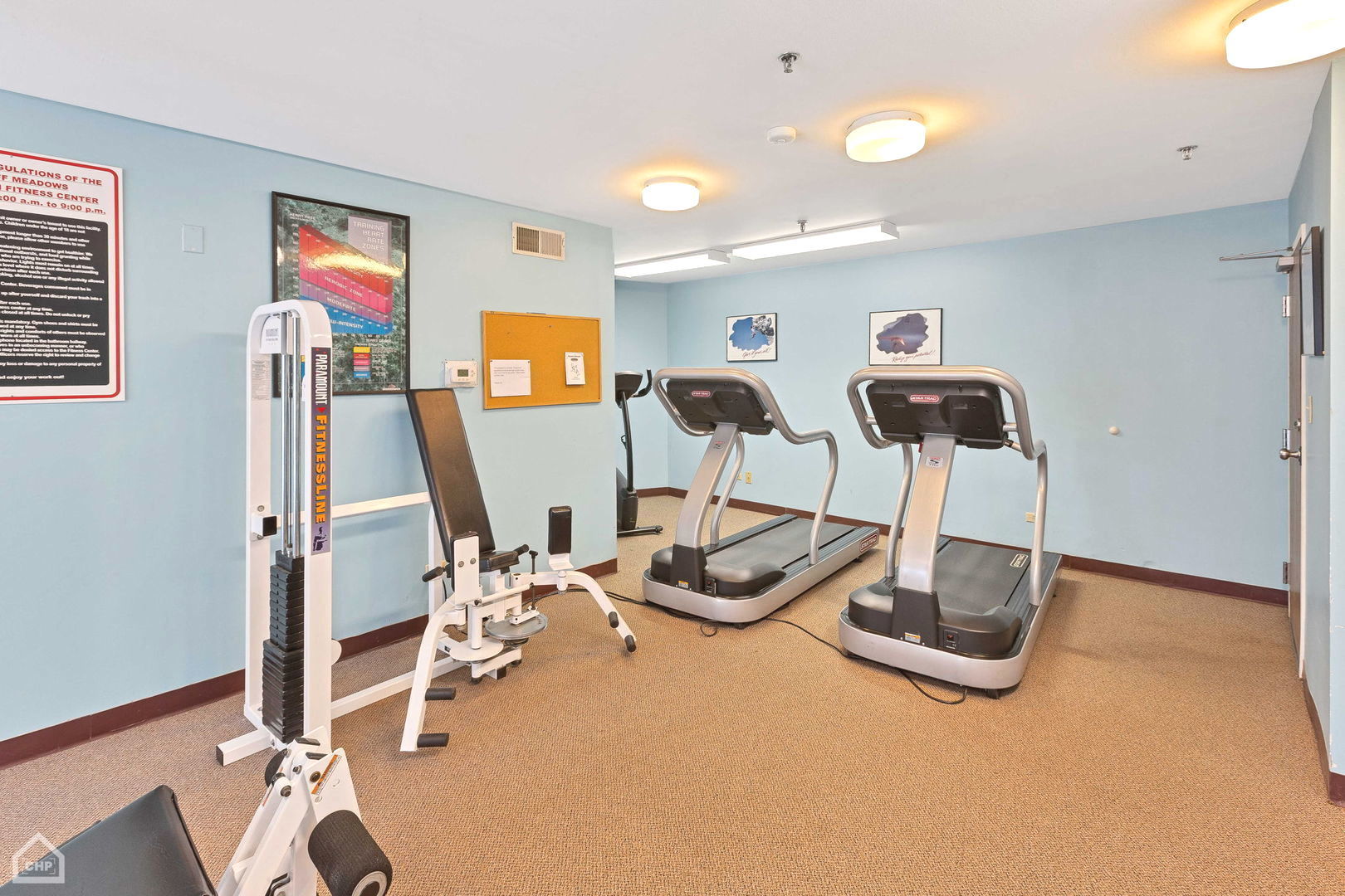 3265 Kirchoff Road, Unit 115 Rolling Meadows, IL 60008 - Photo 16 of 19 a room with gym equipment and wooden floor